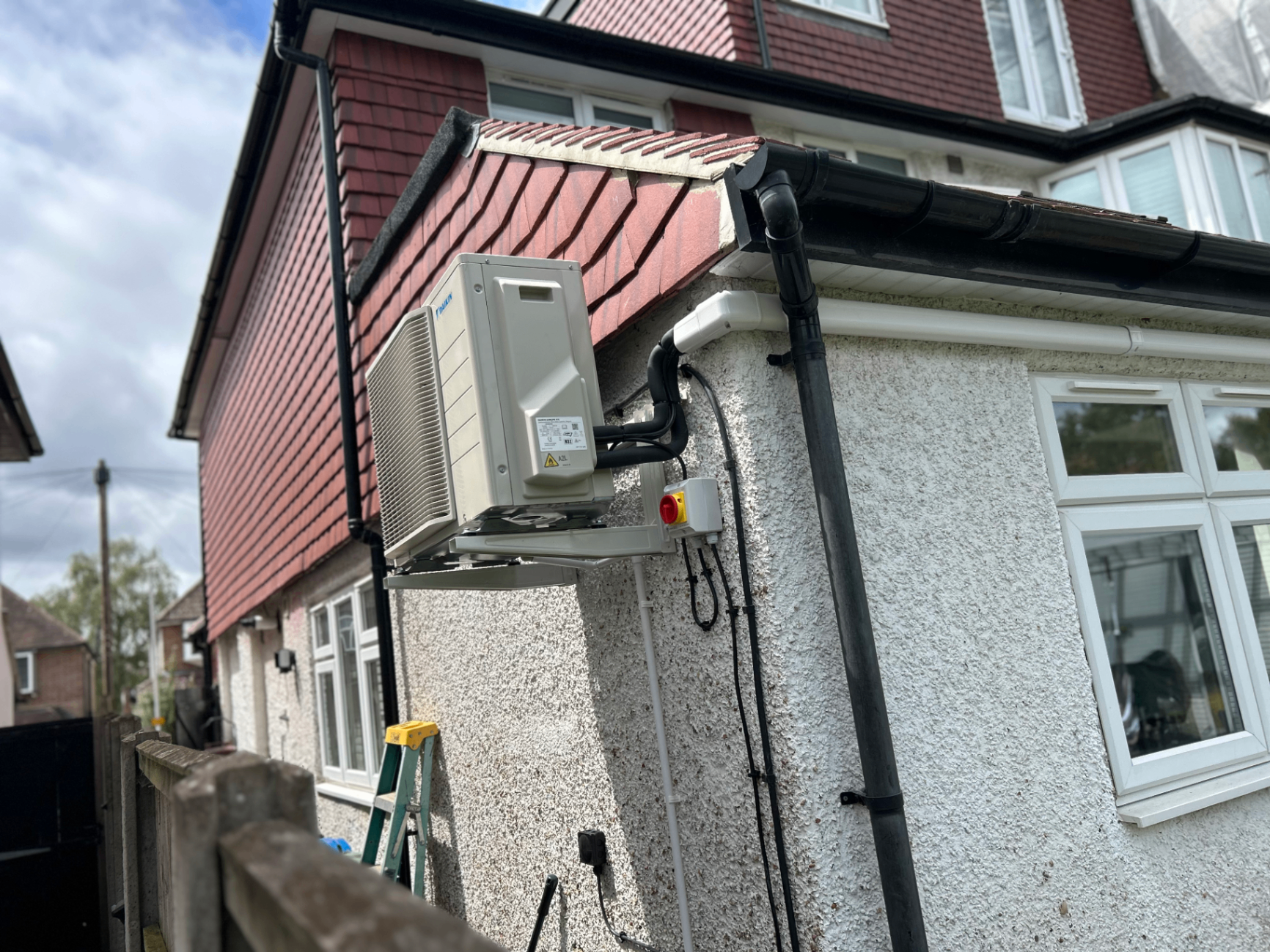Outdoor air conditioning condenser mounted high on an exterior wall at a Battersea property